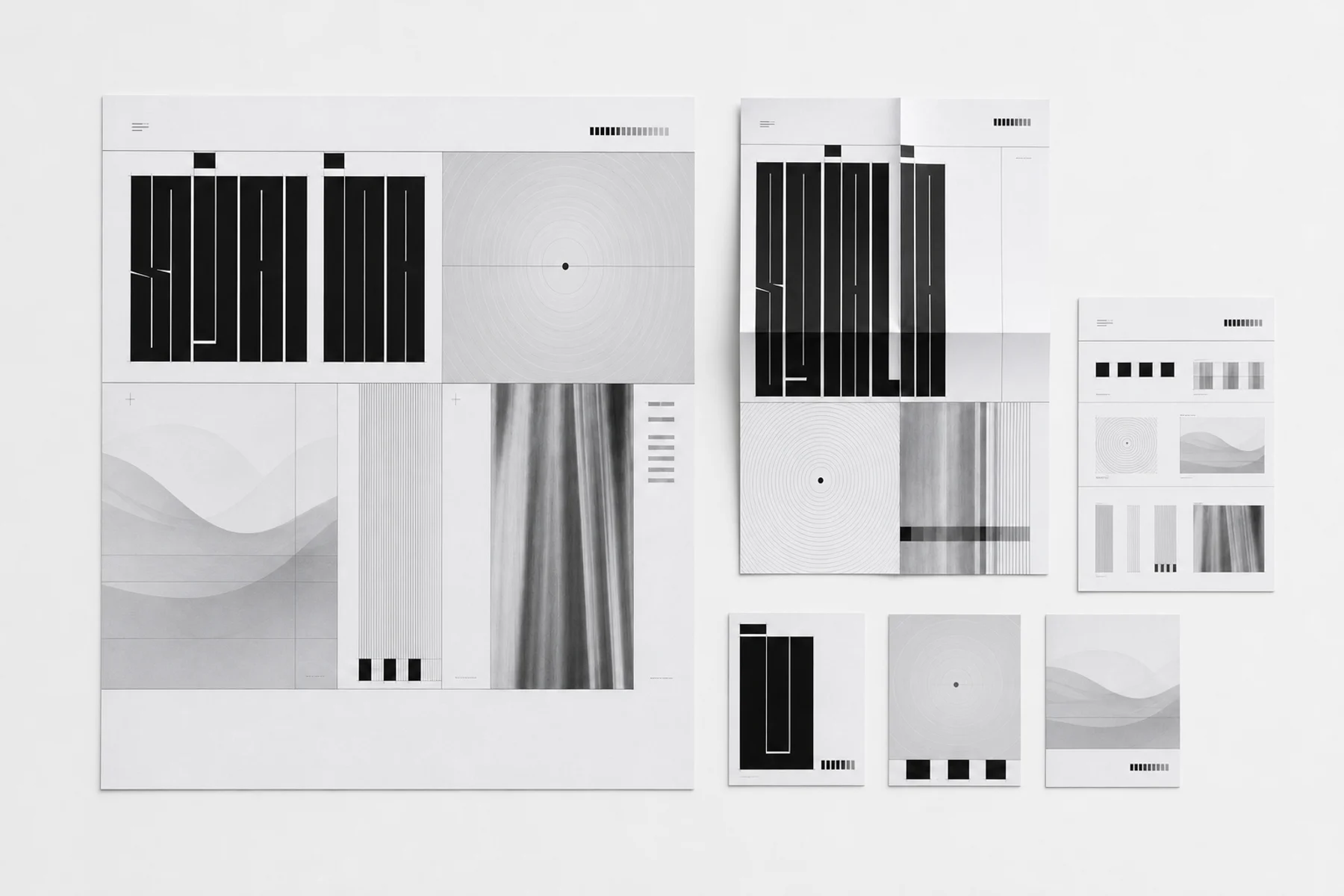 A monochrome identity system arranged across posters, cards, and printed design standards.